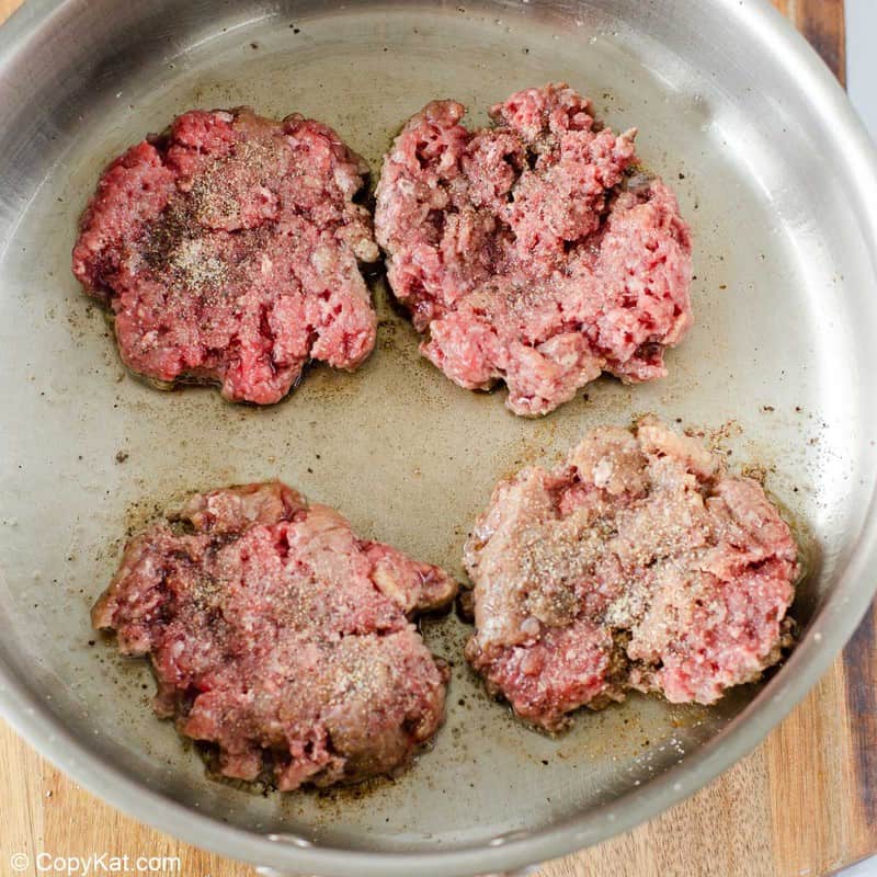 smashed ground beef patties in a skillet