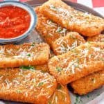 copycat TGI Friday's Fried Mozzarella Sticks and marinara sauce on a platter
