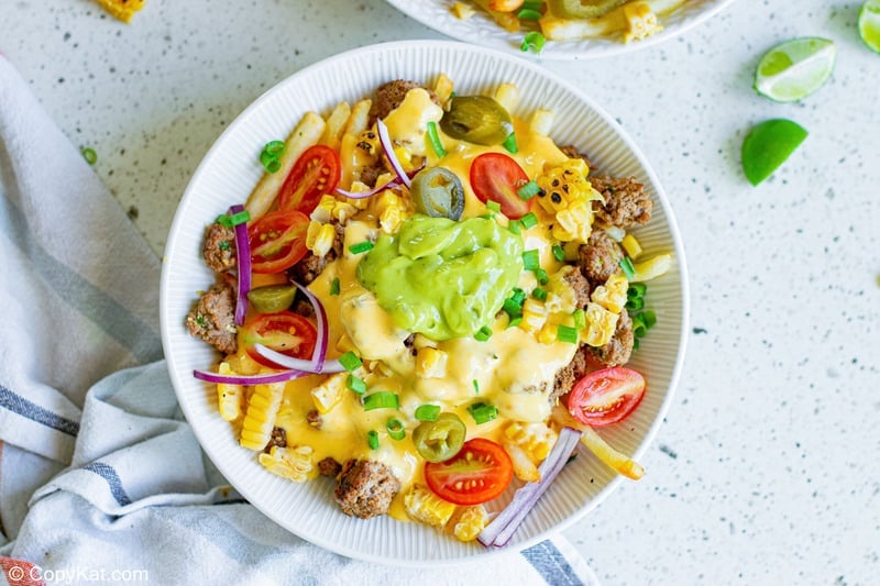 a bowl of homemade Taco Bell Nacho Fries BellGrande and a napkin