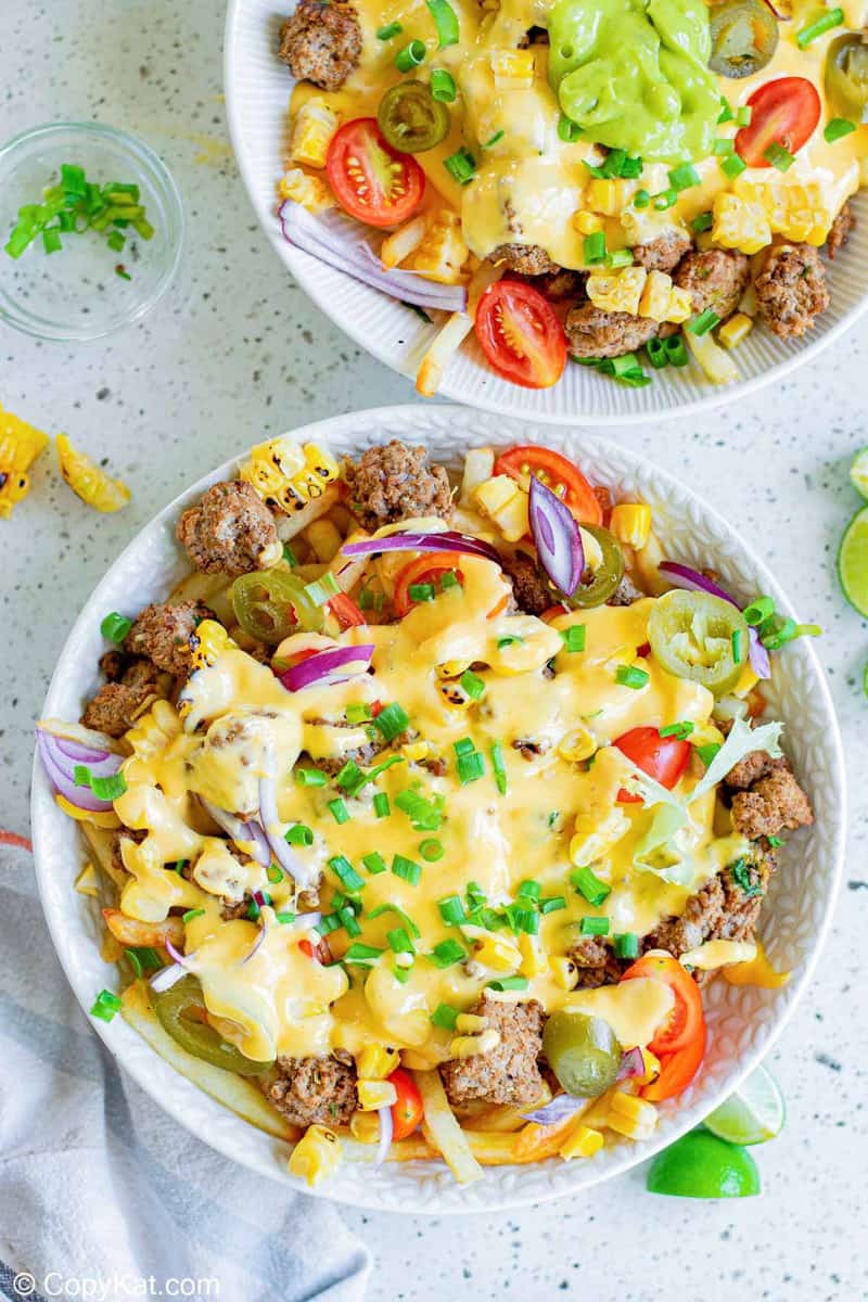 overhead view of two bowls of homemade Taco Bell Nacho Fries BellGrande