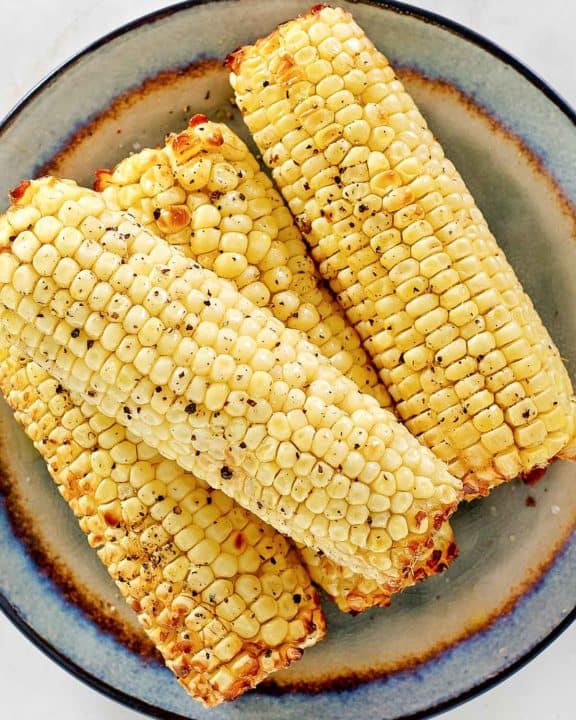 overhead view of air fried corn on the cob on a plate