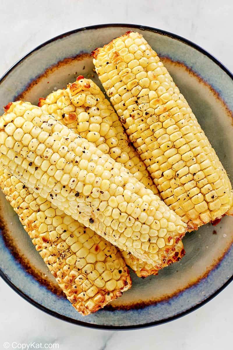 overhead view of air fried corn on the cob on a plate