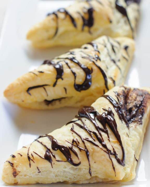 three homemade Arby's chocolate turnovers on a platter