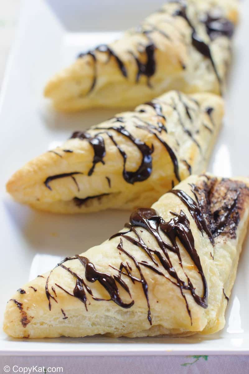 three homemade Arby's chocolate turnovers on a platter