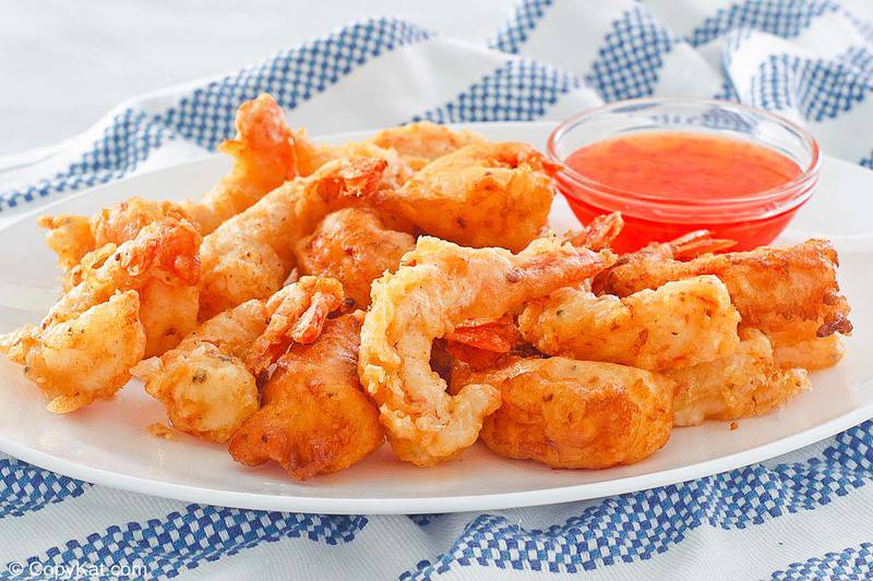 beer battered shrimp and dipping sauce on a plate