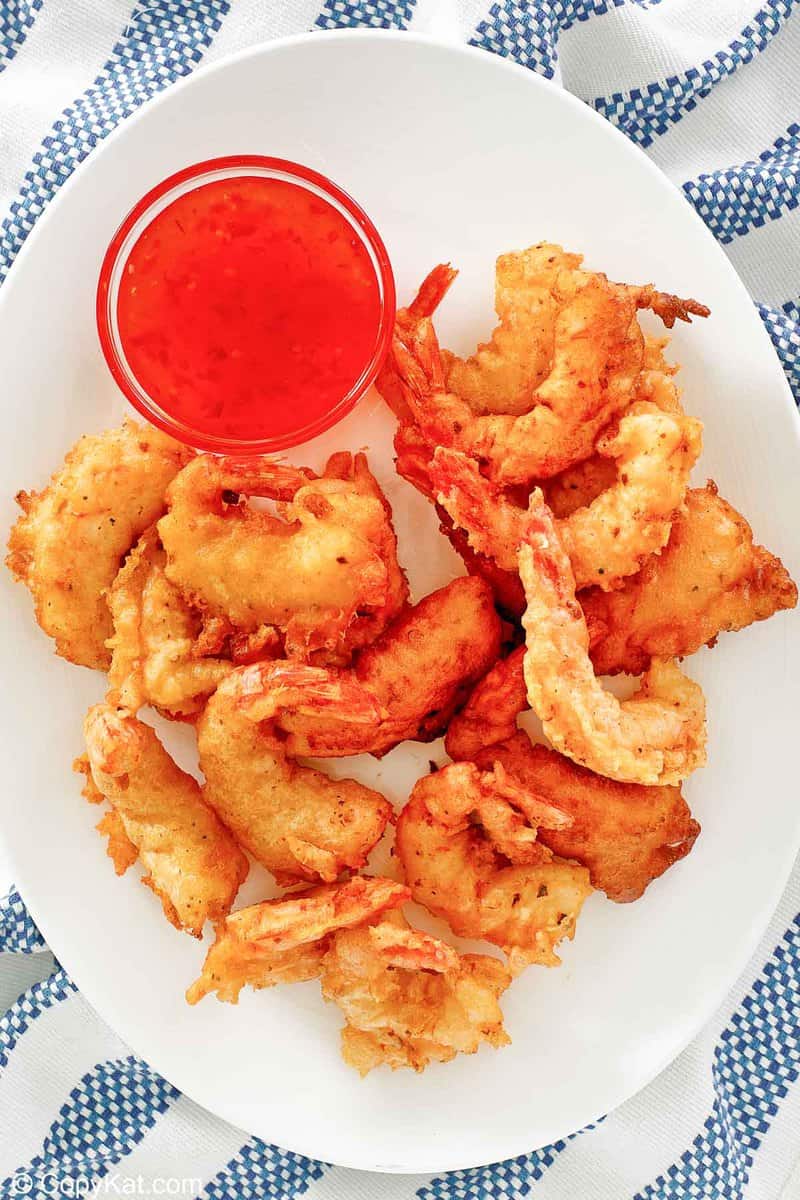 overhead view of beer battered fried shrimp on a platter