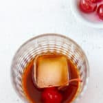 overhead view of a Black Russian drink and cherries
