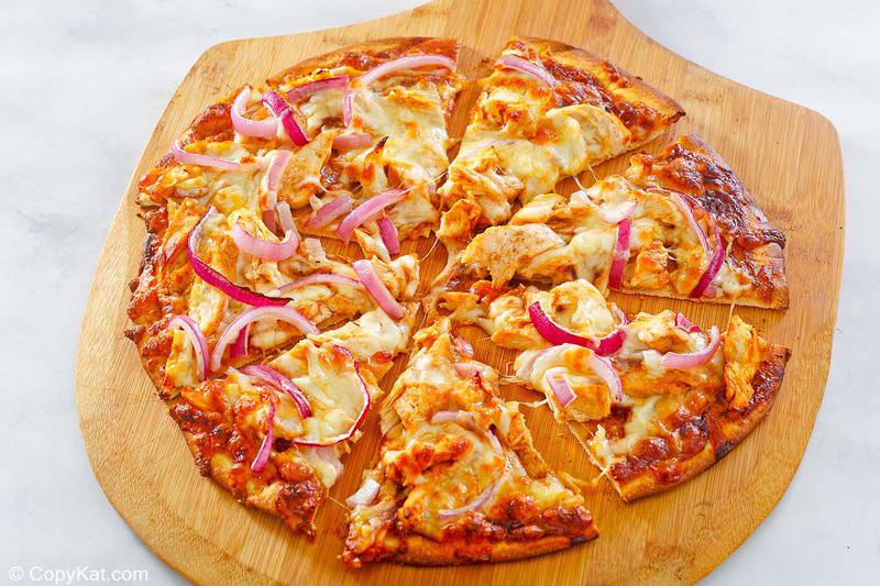 slices of homemade CPK barbecue chicken pizza on a pizza peel