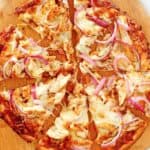 overhead view of homemade CPK bbq chicken pizza on a pizza peel