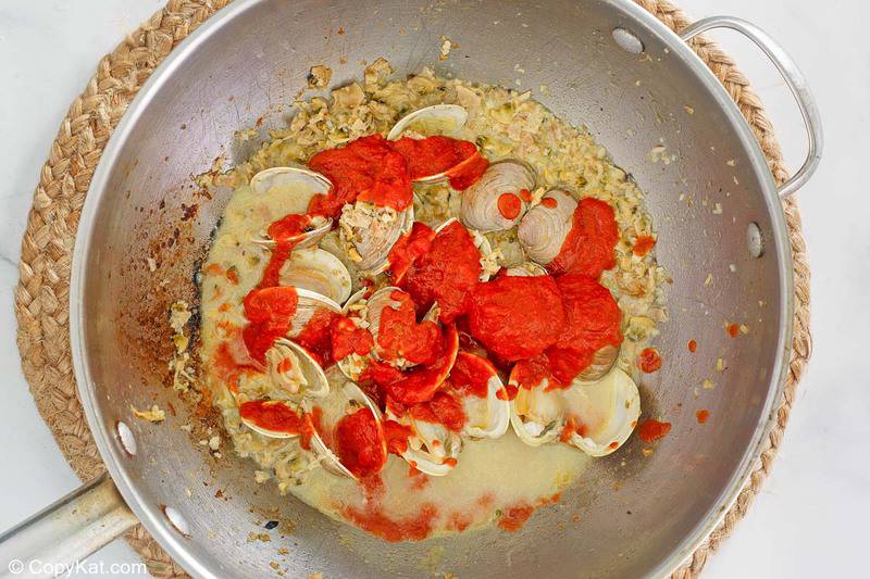 clams, garlic, and marinara sauce in a pan