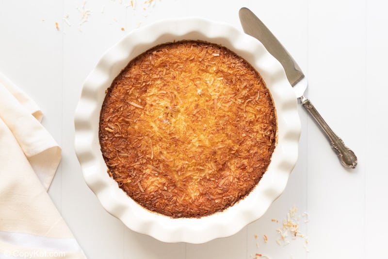 overhead view of a coconut custard pie, pie server, and napkin