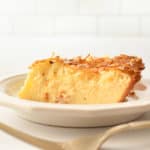 a slice of coconut custard pie and a fork