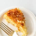 a slice of coconut custard pie and a fork on a plate