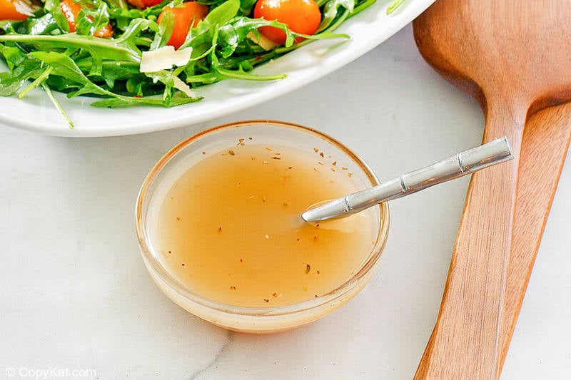 homemade Italian dressing and a spoon in a small bowl