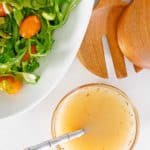 overhead view of homemade Italian salad dressing and a salad