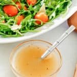 small bowl of homemade Italian dressing and a salad