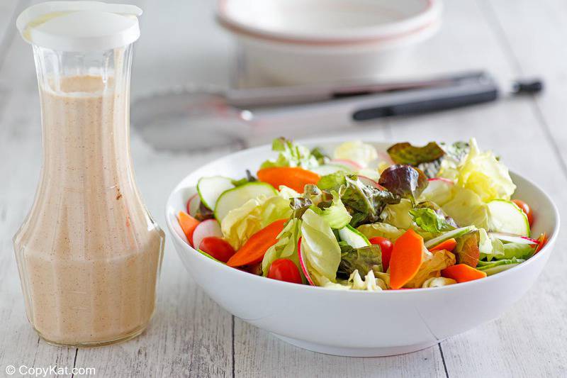 a bottle of homemade Houston's buttermilk garlic dressing and a salad