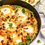 huevos rancheros in a pan and an avocado