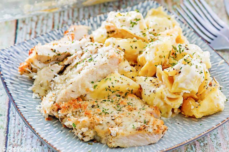 a serving of homemade Olive Garden Asiago Tortelloni Alfredo with grilled chicken
