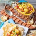 pineapple mango salsa on tortilla chips and in a fresh pineapple