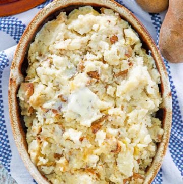 overhead view of roasted garlic mashed potatoes in a serving dish