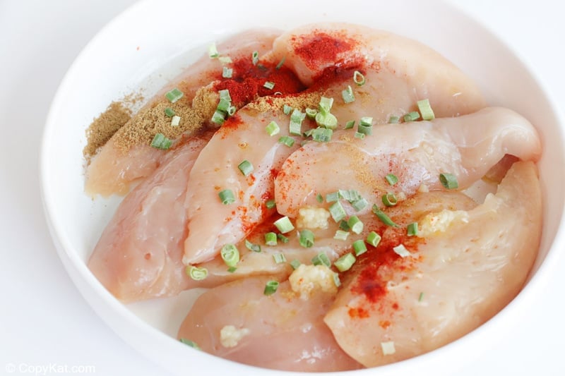fajita seasoning and chicken tenderloins in a bowl