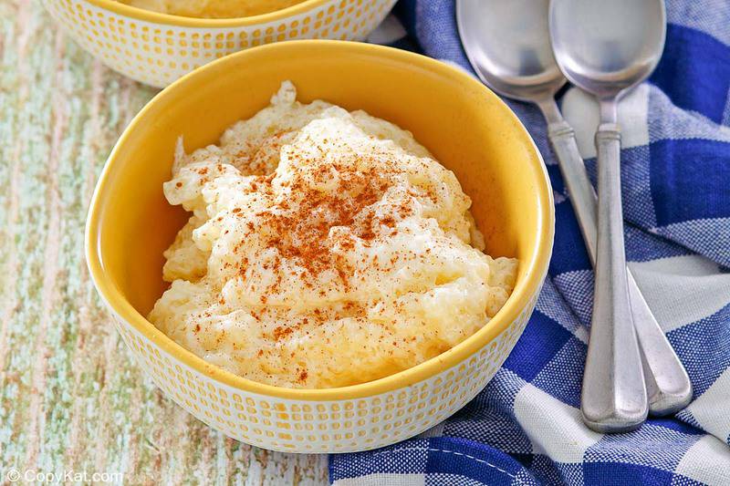 a bowl of homemade tapioca pudding next to 2 spoons on a napkin