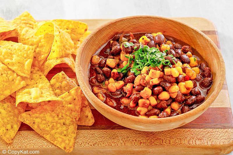 tortilla chips and a bowl of black bean and corn salad