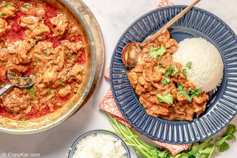 Indian butter chicken in a pan and a bowl with rice