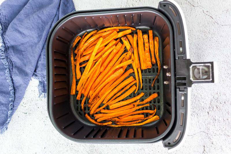 air fried carrot fries in an air fryer basket