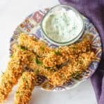 homemade Disney fried pickle spears and ranch dressing on a plate