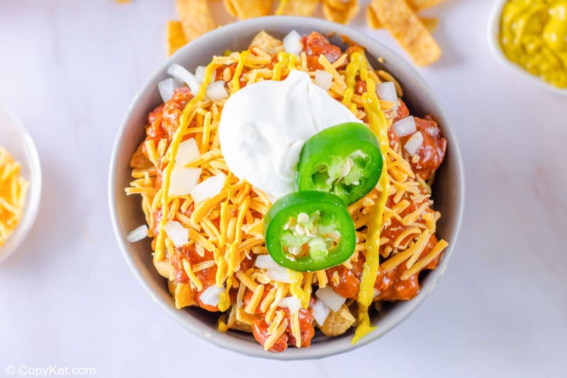 sour cream and jalapeno topping on a Frito pie