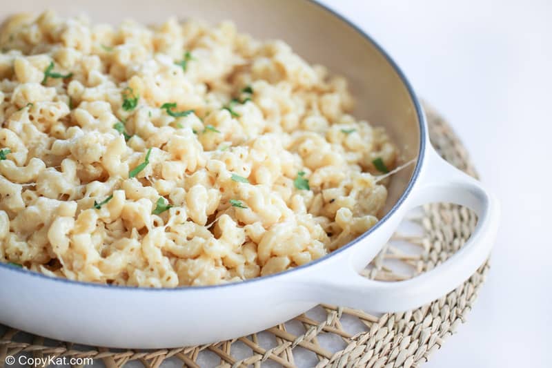 Instant Pot white cheddar macaroni and cheese in a serving dish on a braided mat