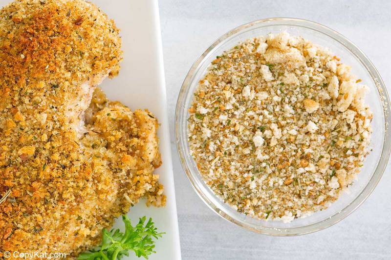 homemade Italian seasoned bread crumbs in a bowl next to breaded chicken