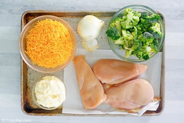 keto chicken divan casserole ingredients on a baking sheet