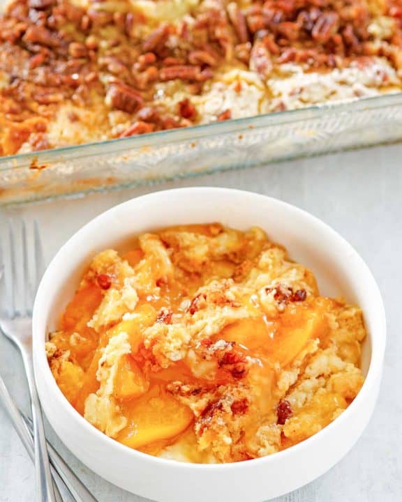 peach dump cake in a bowl and baking dish