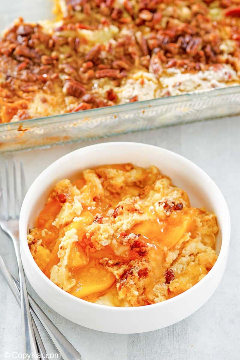 peach dump cake in a bowl and baking dish