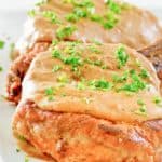 two fried pork chops with gravy