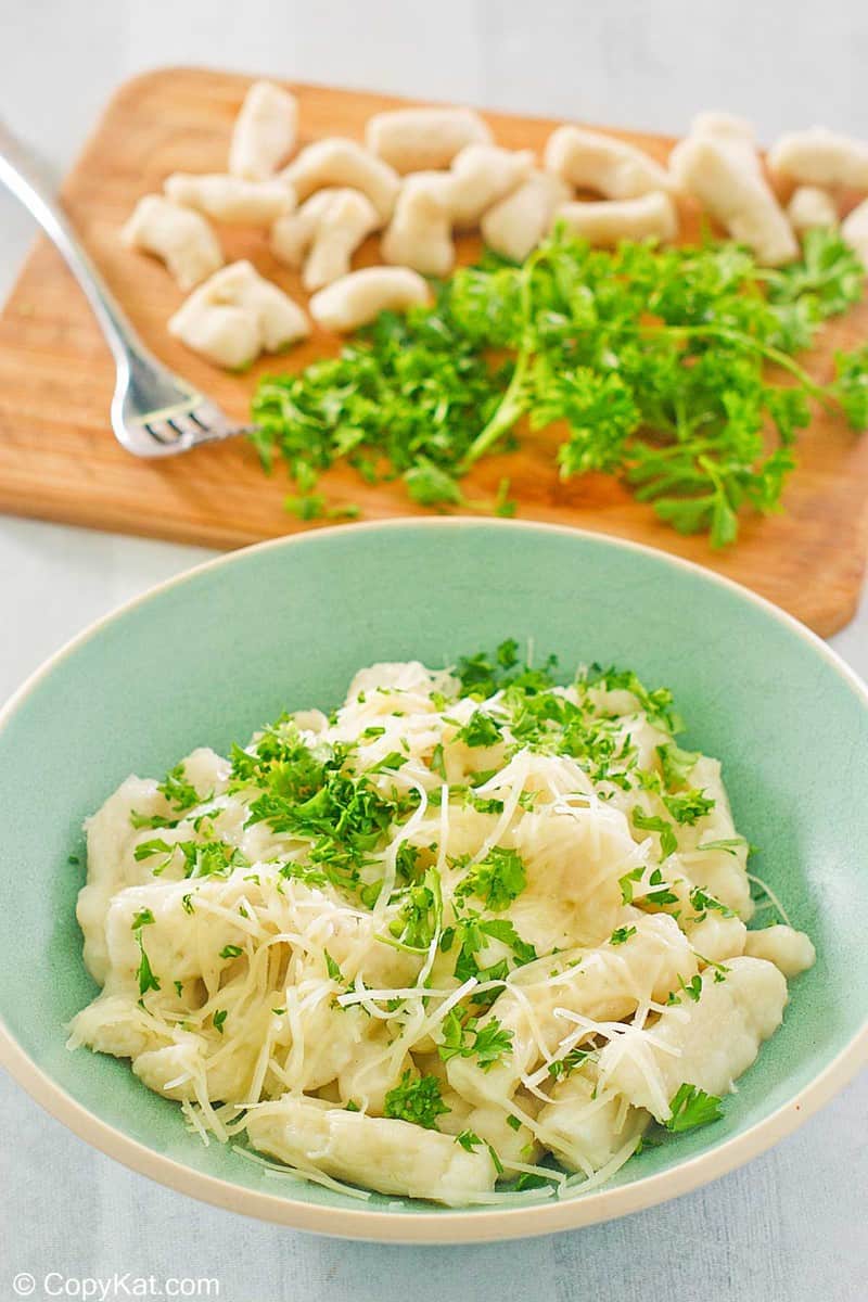 a bowl of homemade potato gnocchi topped with parmesan and parsley