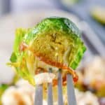 crispy brussel sprout, glaze, and fried onion on a fork