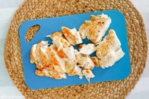 sliced cooked chicken breast on a cutting board