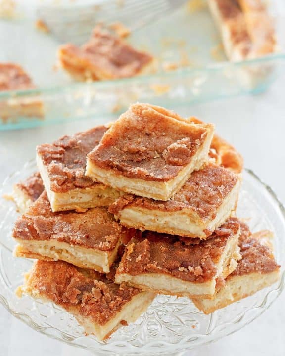 sopapilla cheesecake slices stacked on a cake stand