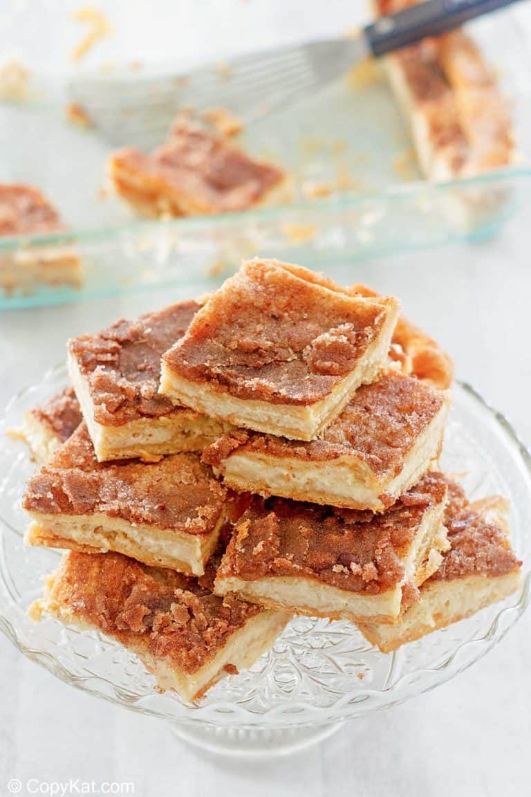 sopapilla cheesecake slices stacked on a cake stand