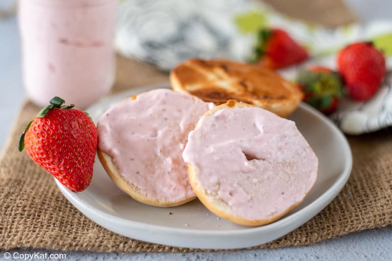 homemade strawberry cream cheese on a bagel and fresh strawberries