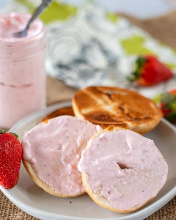 strawberry cream cheese spread on a bagel