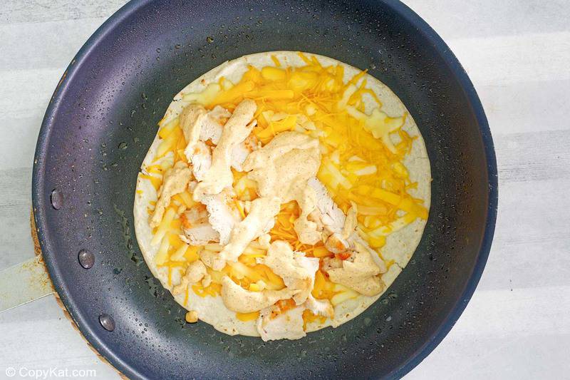 homemade Taco Bell chicken quesadilla cooking in a skillet