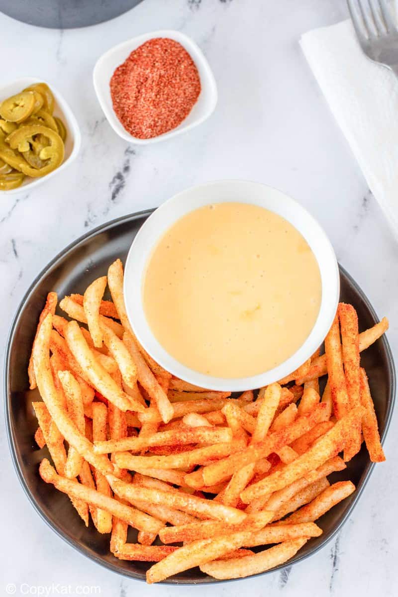 overhead view of homemade Taco Bell nacho fries and cheese sauce