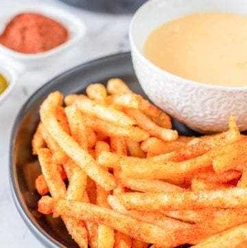 homemade Taco Bell Nacho Fries and cheese sauce on a plate