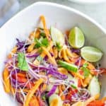 Thai noodle salad and lime wedges in a bowl