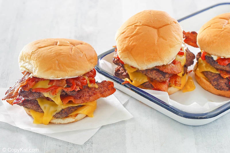 homemade Wendy's baconator burgers on parchment paper